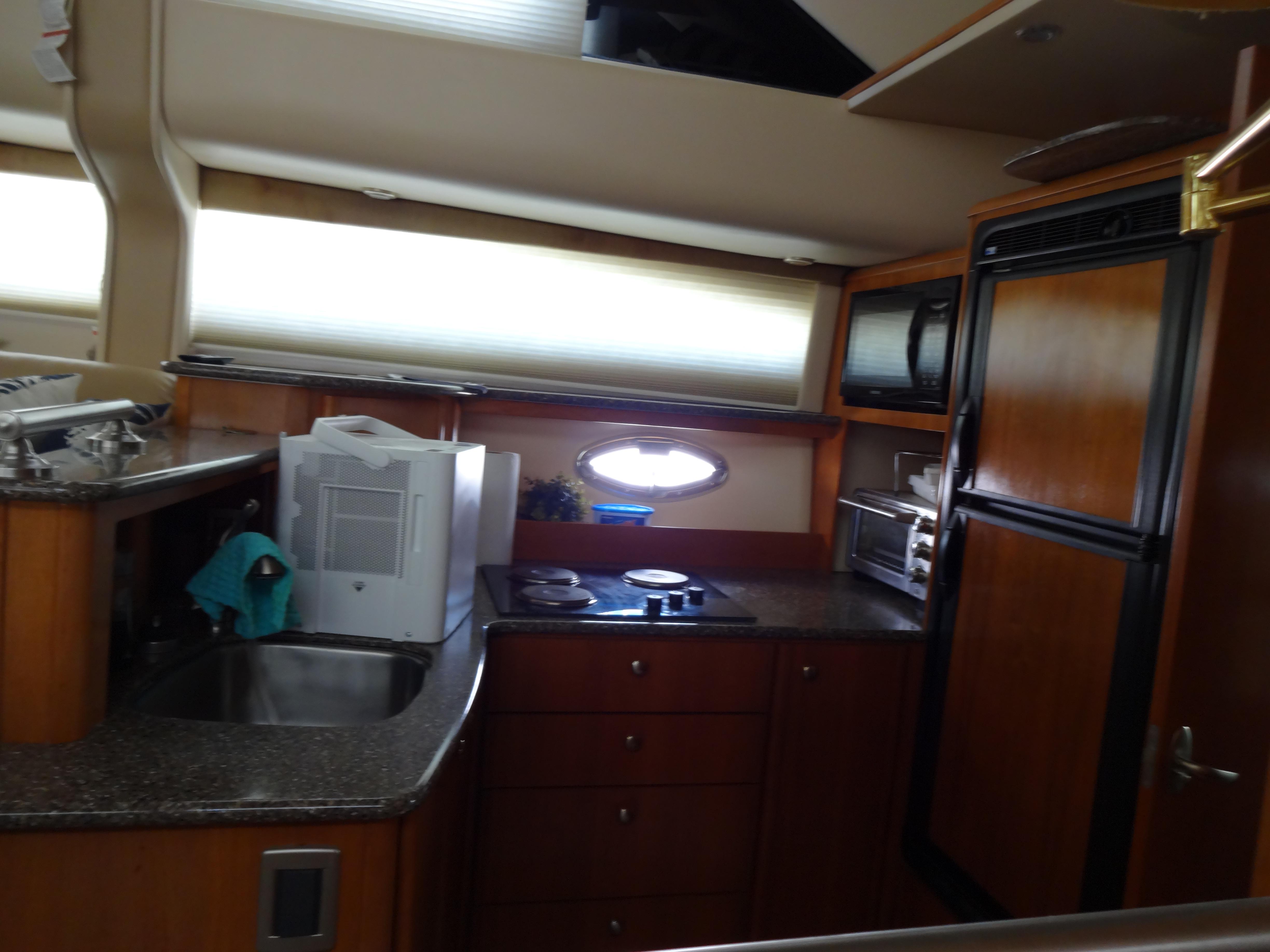 Slide: The Image of 2004 Meridian 408 Motoryacht kitchen with modern appliances and wood cabinetry. - 35