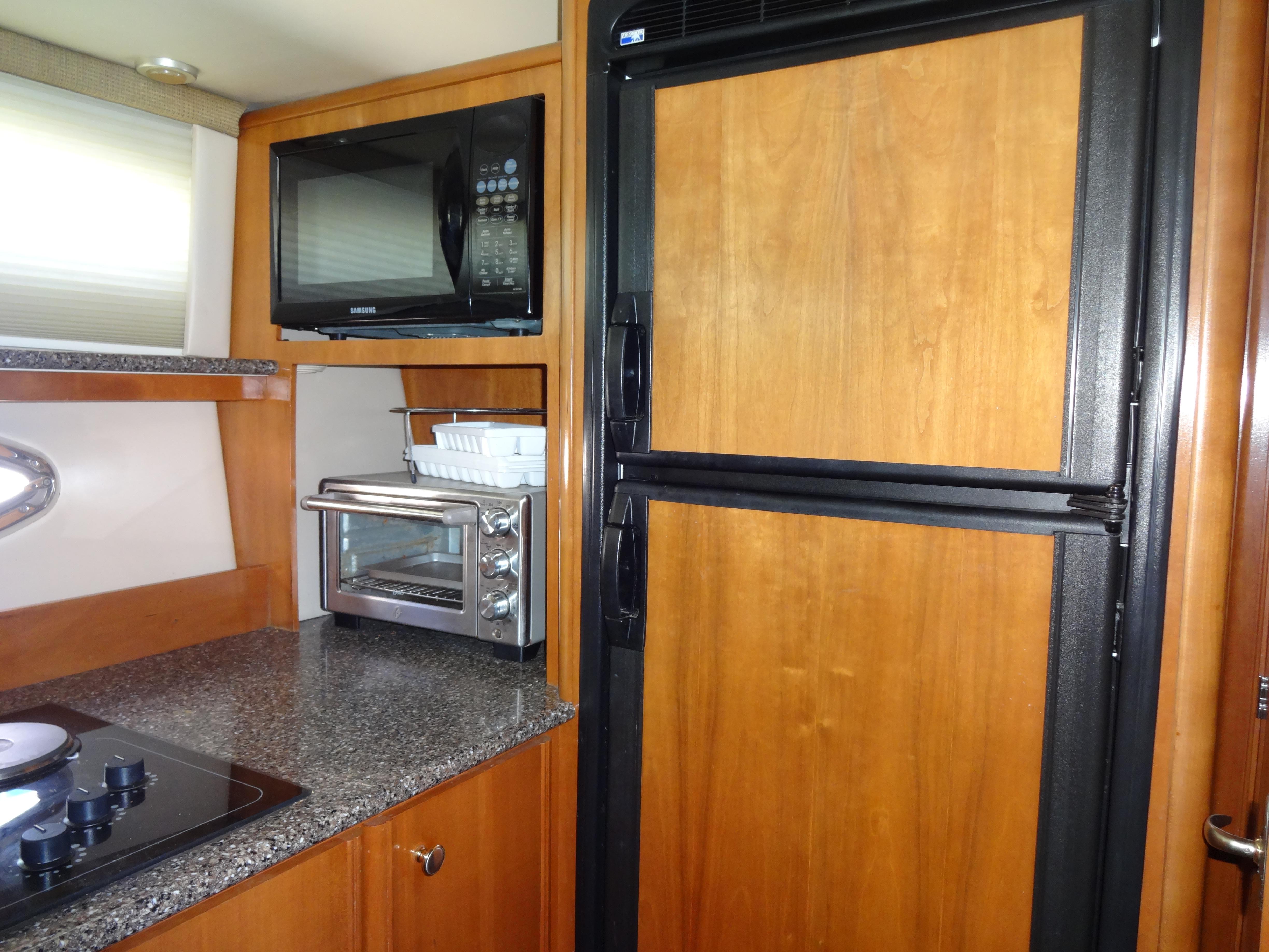 Slide: The Image of Kitchen area of 2004 Meridian 408 Motoryacht with microwave, toaster oven, and refrigerator. - 37