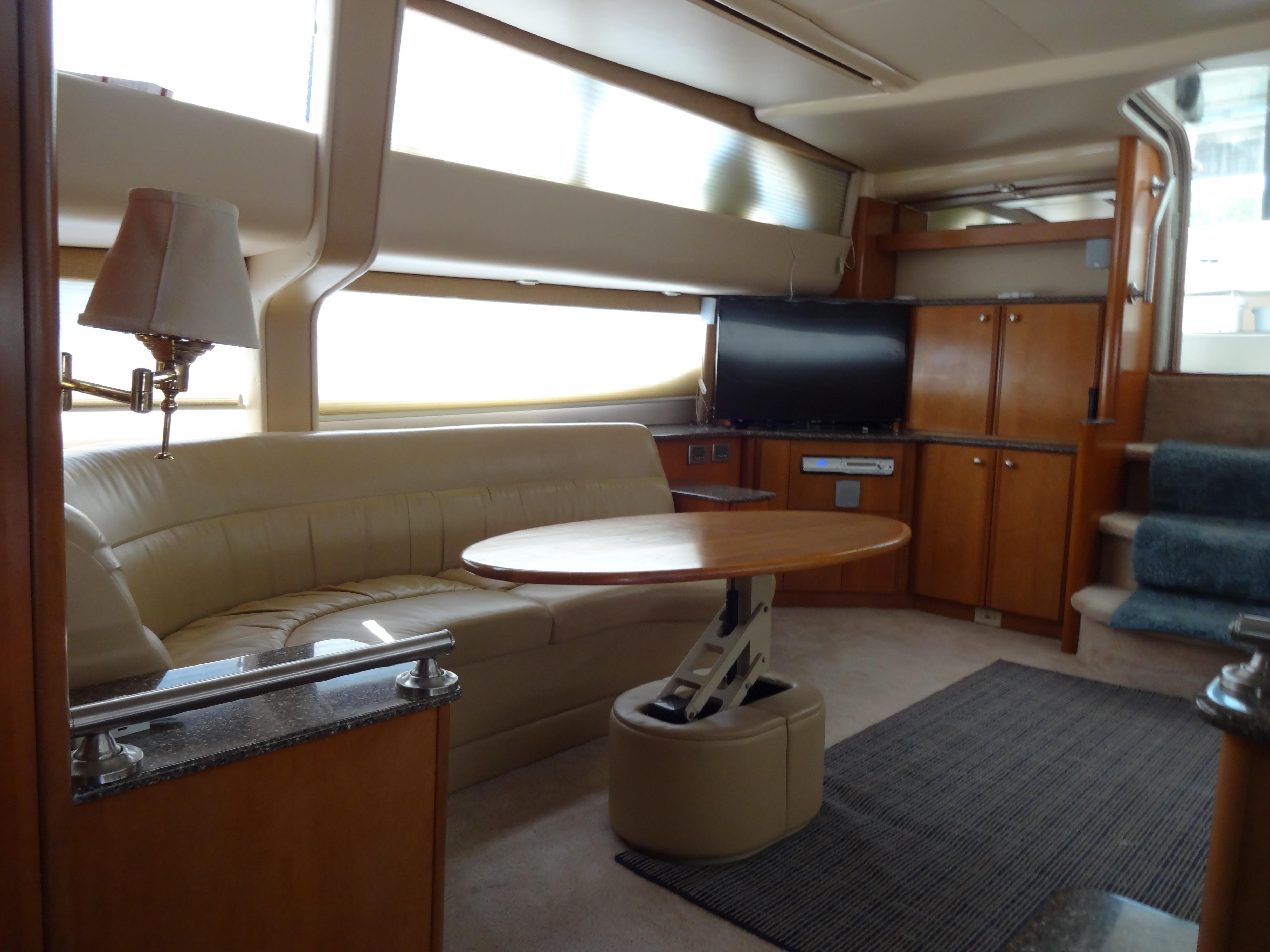 Slide: The Image of Interior of 2004 Meridian 408 Motoryacht with leather seating, TV, and wooden cabinetry. - 39