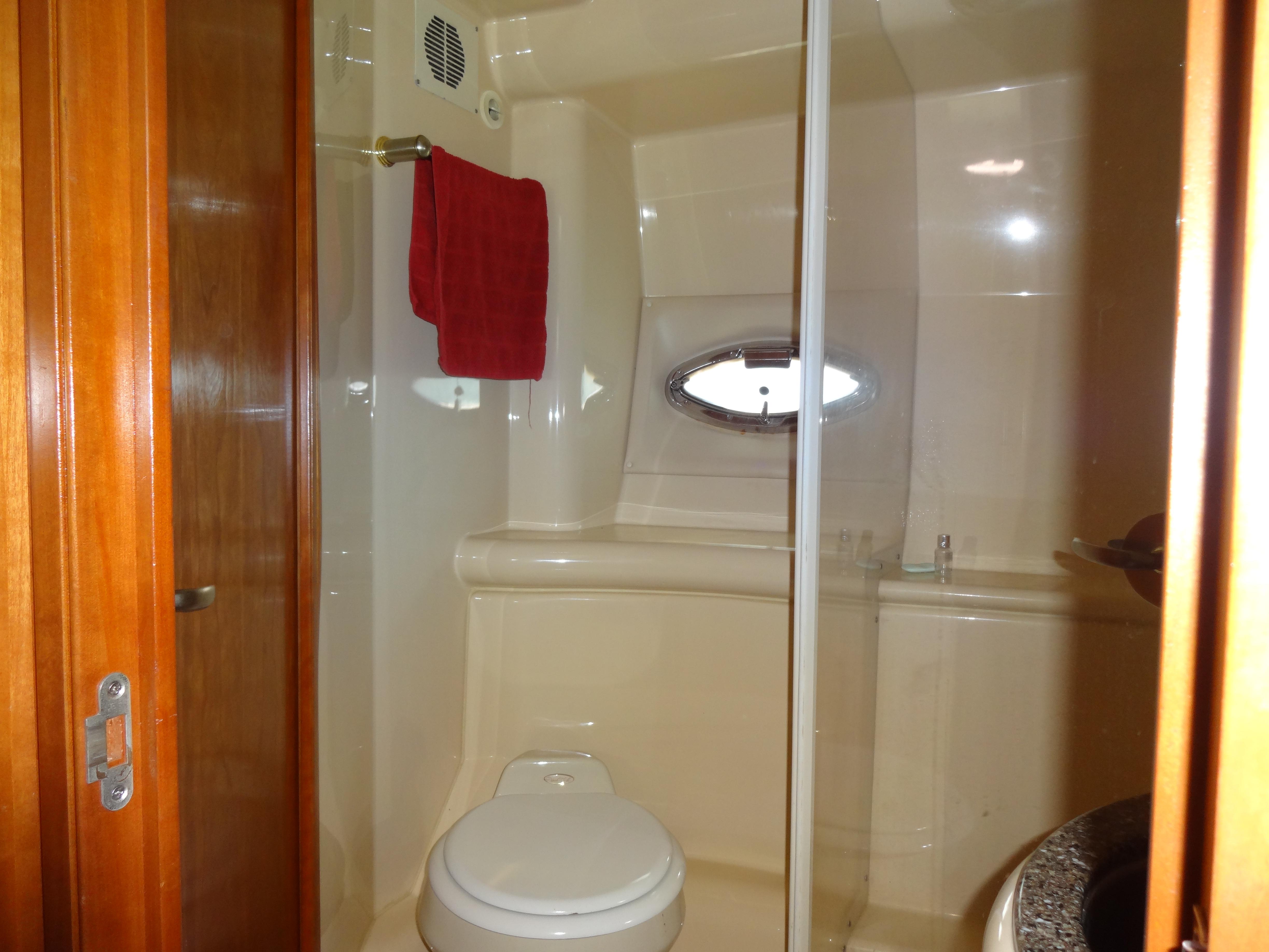 Slide: The Image of Bathroom in 2004 Meridian 408 Motoryacht with shower, toilet, and wooden door. - 42