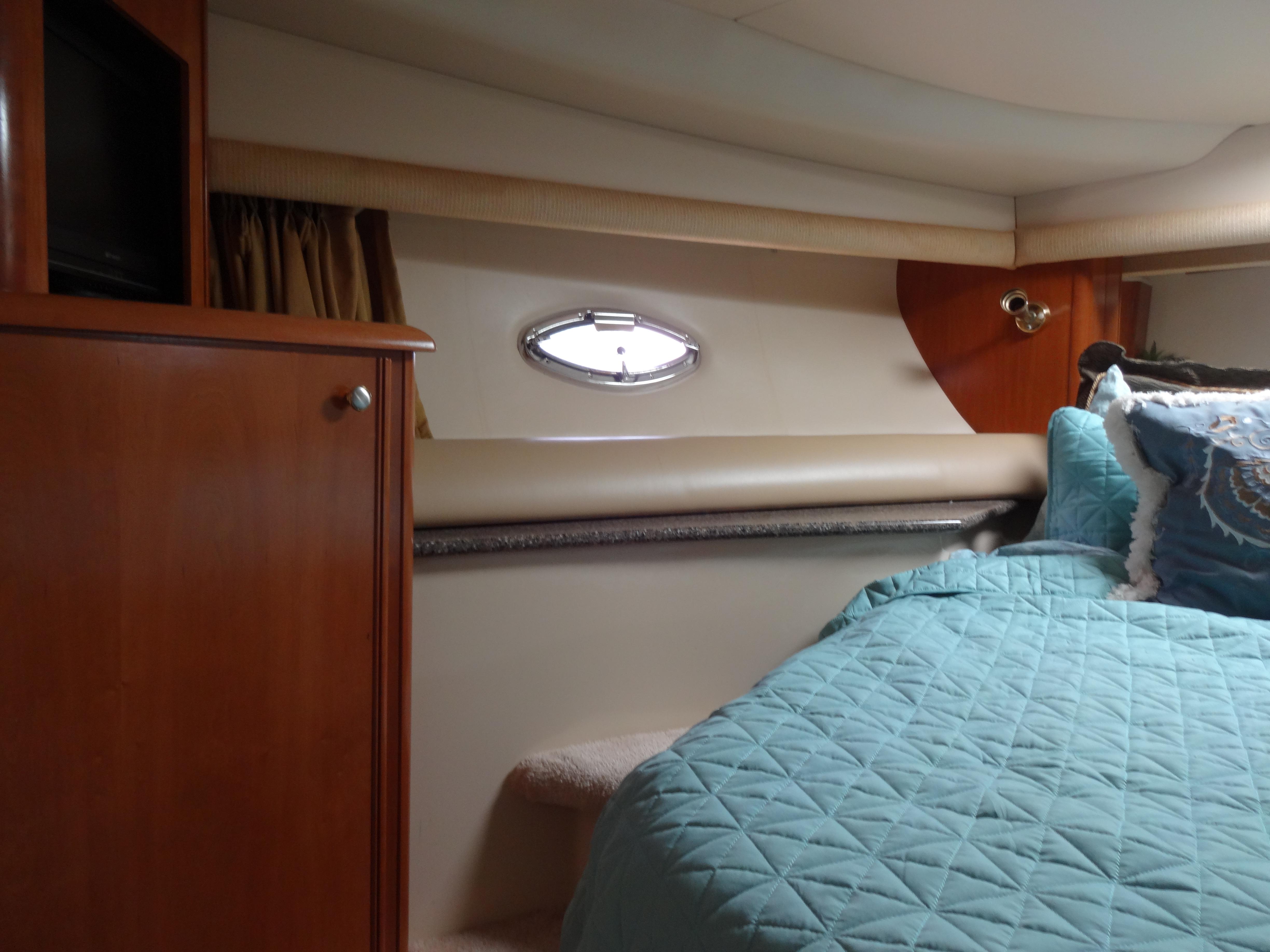 Slide: The Image of Interior cabin of 2004 Meridian 408 Motoryacht with blue quilted bedding. - 48