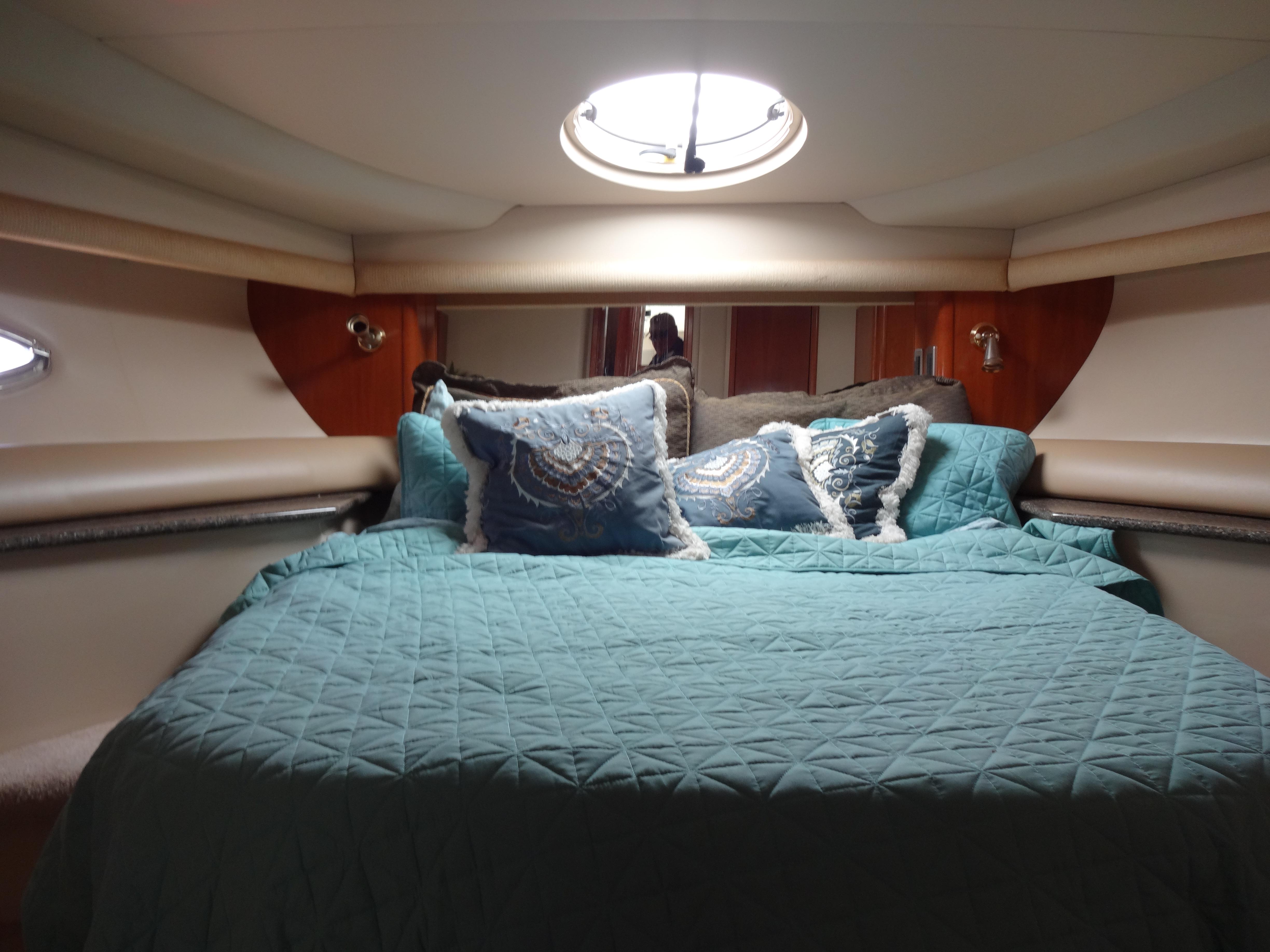 Slide: The Image of Luxurious bedroom interior of 2004 Meridian 408 Motoryacht with teal bedding and decorative pillows. - 49