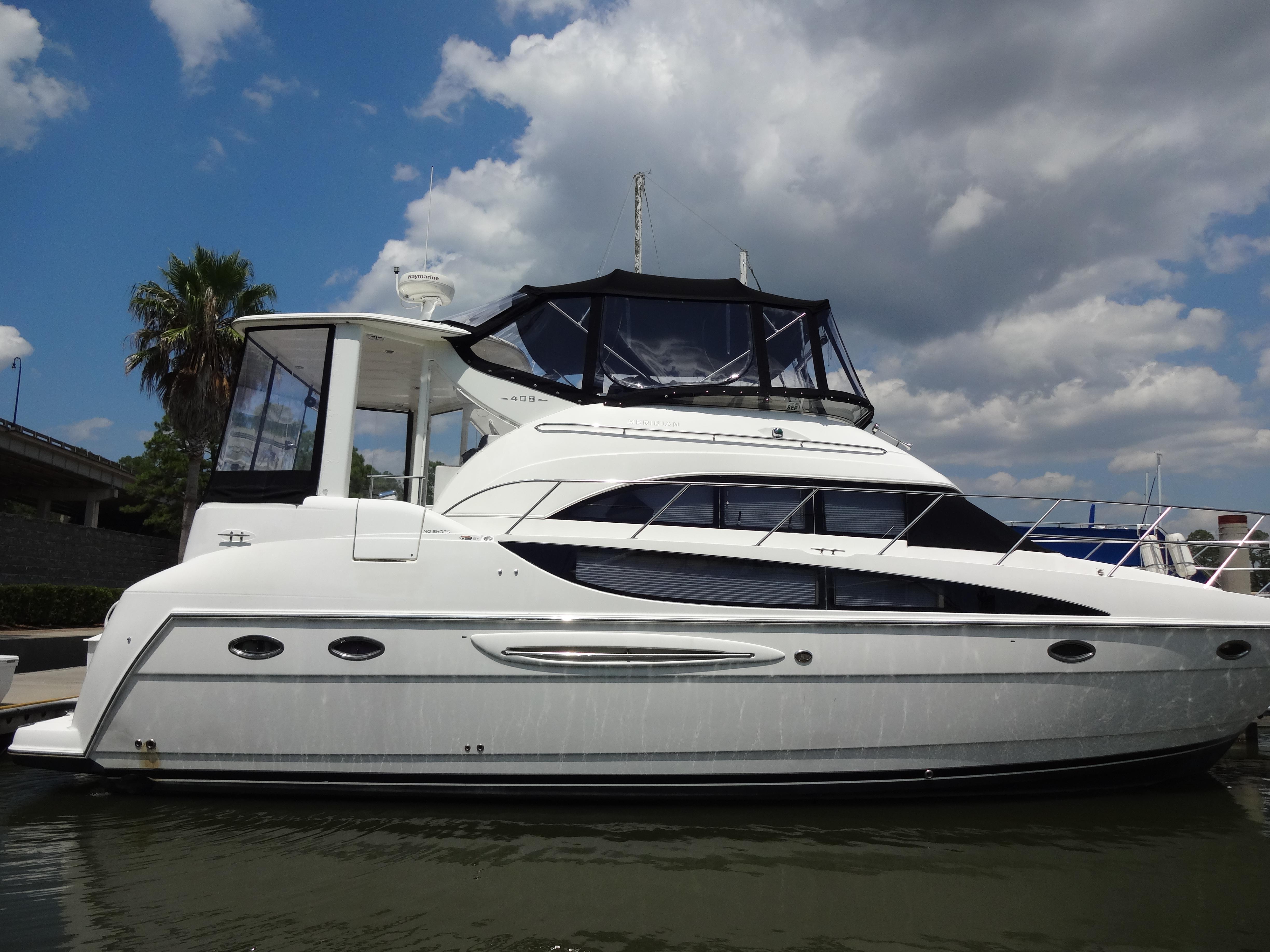 Slide: The Image of 2004 Meridian 408 Motoryacht docked under a partly cloudy sky. - 8