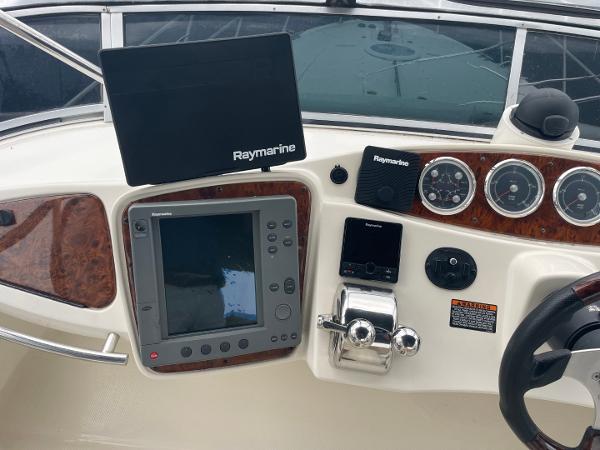 Slide: The Image of 2004 Meridian 459 Motoryacht dashboard with Raymarine navigation equipment and controls. - 12