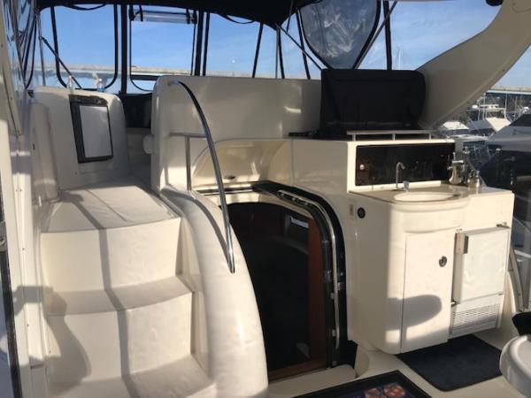 Slide: The Image of 2004 Meridian 459 Motoryacht interior with stairs, seating, and kitchenette. - 16