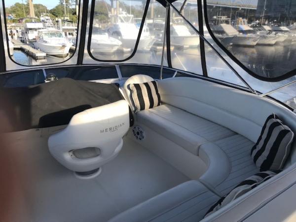 Slide: The Image of Luxurious 2004 Meridian 459 Motoryacht interior with plush seating and striped cushions at marina. - 20