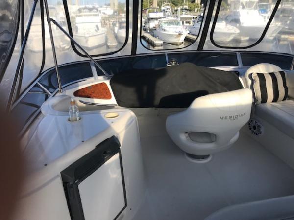 Slide: The Image of 2004 Meridian 459 Motoryacht interior with seating and marina view. - 21