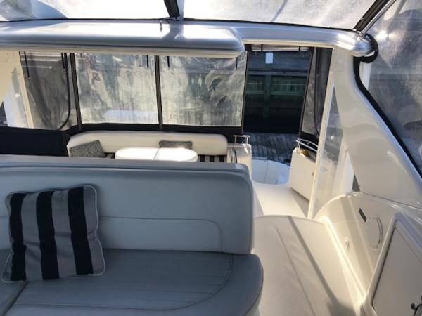 Slide: The Image of 2004 Meridian 459 Motoryacht interior with seating, table, and large windows. - 22