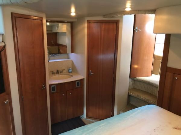 Slide: The Image of 2004 Meridian 459 Motoryacht interior with wood cabinetry and cozy sleeping area. - 35