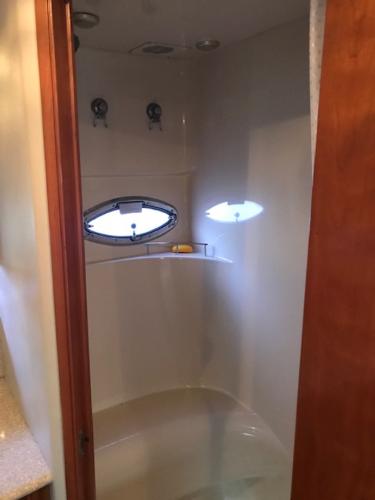 Slide: The Image of 2004 Meridian 459 Motoryacht shower with oval window and modern fixtures. - 36