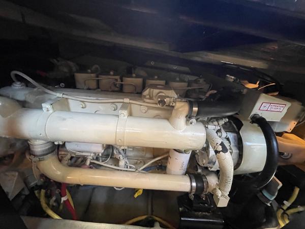 Slide: The Image of Engine compartment of a 2004 Meridian 459 Motoryacht, showcasing mechanical components and piping. - 42