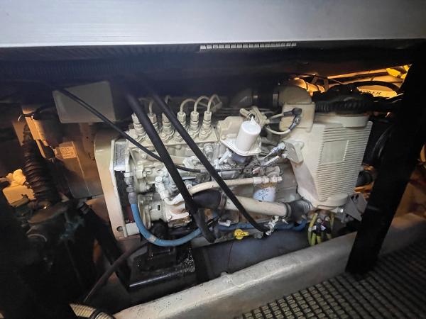 Slide: The Image of Engine compartment of a 2004 Meridian 459 Motoryacht, showcasing mechanical components and wiring. - 43