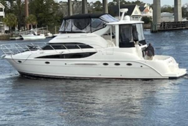 Slide: The Image of 2004 Meridian 459 Motoryacht cruising on a calm river with scenic background. - 7