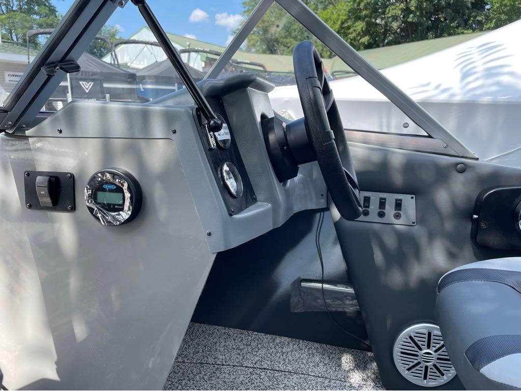Slide: The Image of 2023 MirroCraft 1628 boat dashboard with steering wheel and controls. - 10