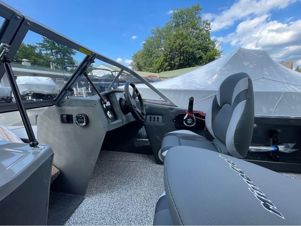 Slide: The Image of Interior of 2023 MirroCraft 1628 boat with steering wheel and seating. - 3