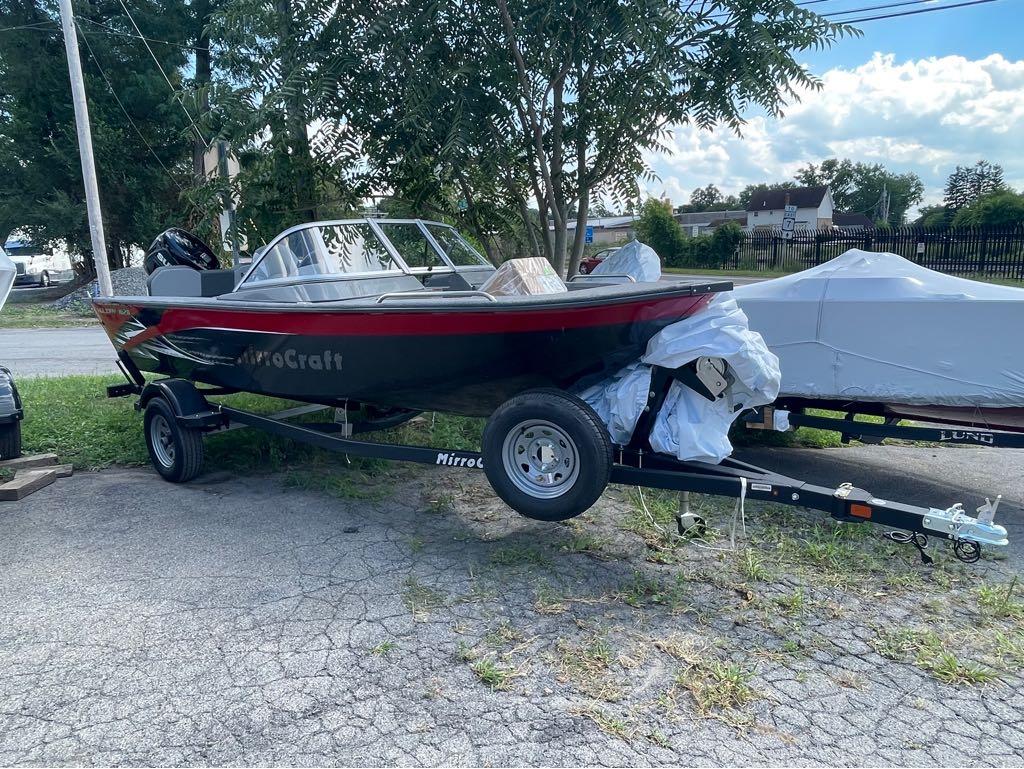 Slide: The Image of 2023 MirroCraft 1628 boat on a trailer, parked outdoors. - 4