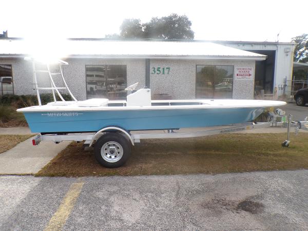 Slide: The Image of 2024 Mitzi Skiffs 17cc boat on trailer outside building. - 0