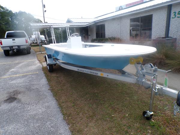 Slide: The Image of 2024 Mitzi Skiffs 17cc boat on a trailer outside a building. - 1