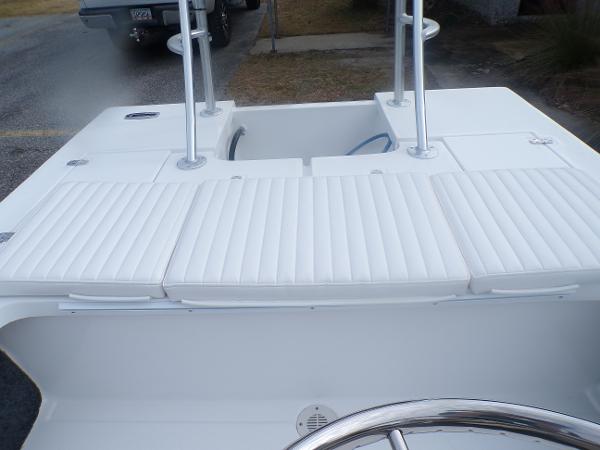 Slide: The Image of 2024 Mitzi Skiffs 17cc boat interior with white cushioned seating and steering wheel. - 10