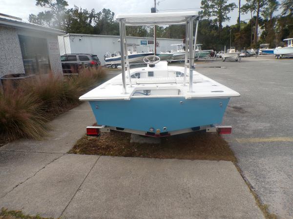 Slide: The Image of 2024 Mitzi Skiffs 17cc boat in a parking lot, rear view. - 2