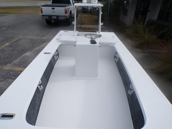 Slide: The Image of 2024 Mitzi Skiffs 17cc center console boat, white interior, parked outdoors. - 6