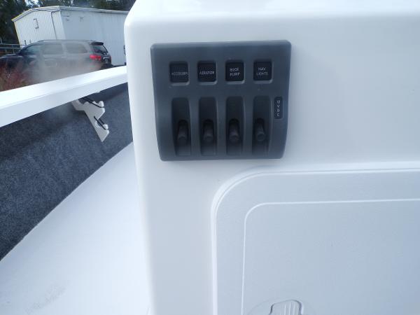 Slide: The Image of Control panel of a 2024 Mitzi Skiffs 17cc boat with various switches. - 9