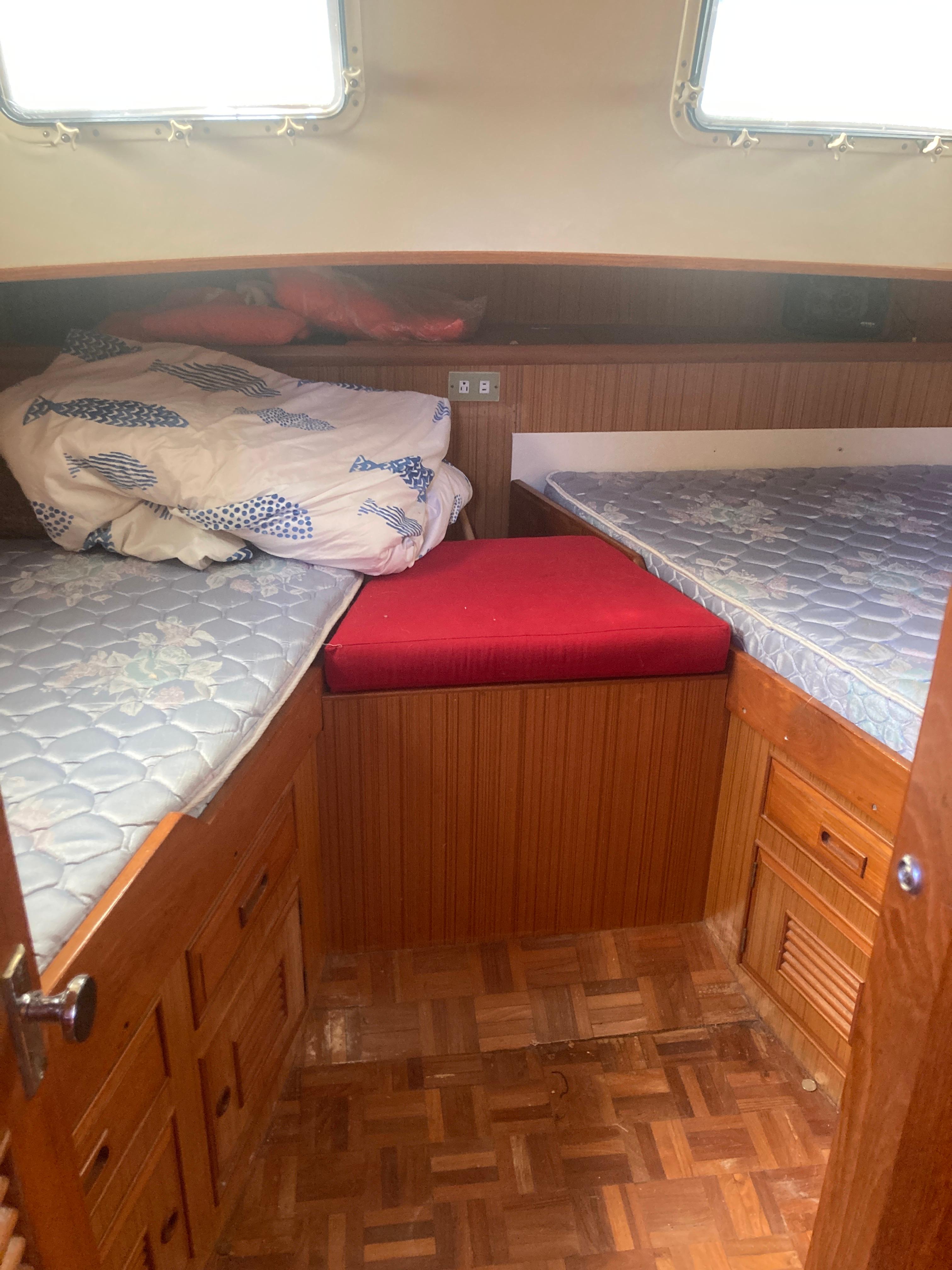 Slide: The Image of 1981 Monk Comfort Monk Motorsailer 38 cabin interior with twin beds and wooden cabinetry. - 10