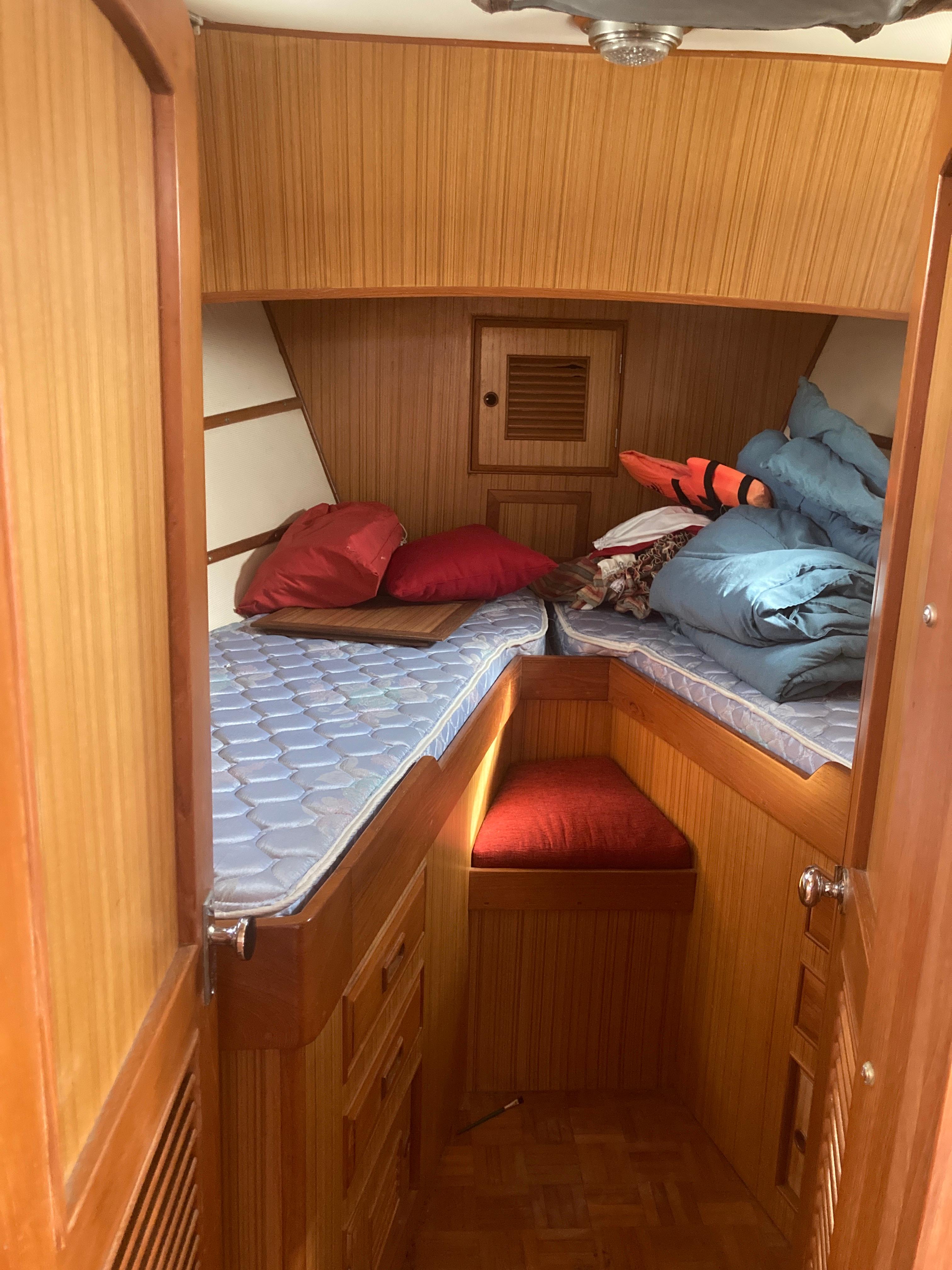 Slide: The Image of 1981 Monk Comfort Monk Motorsailer 38 cabin interior with wooden paneling and bedding. - 18