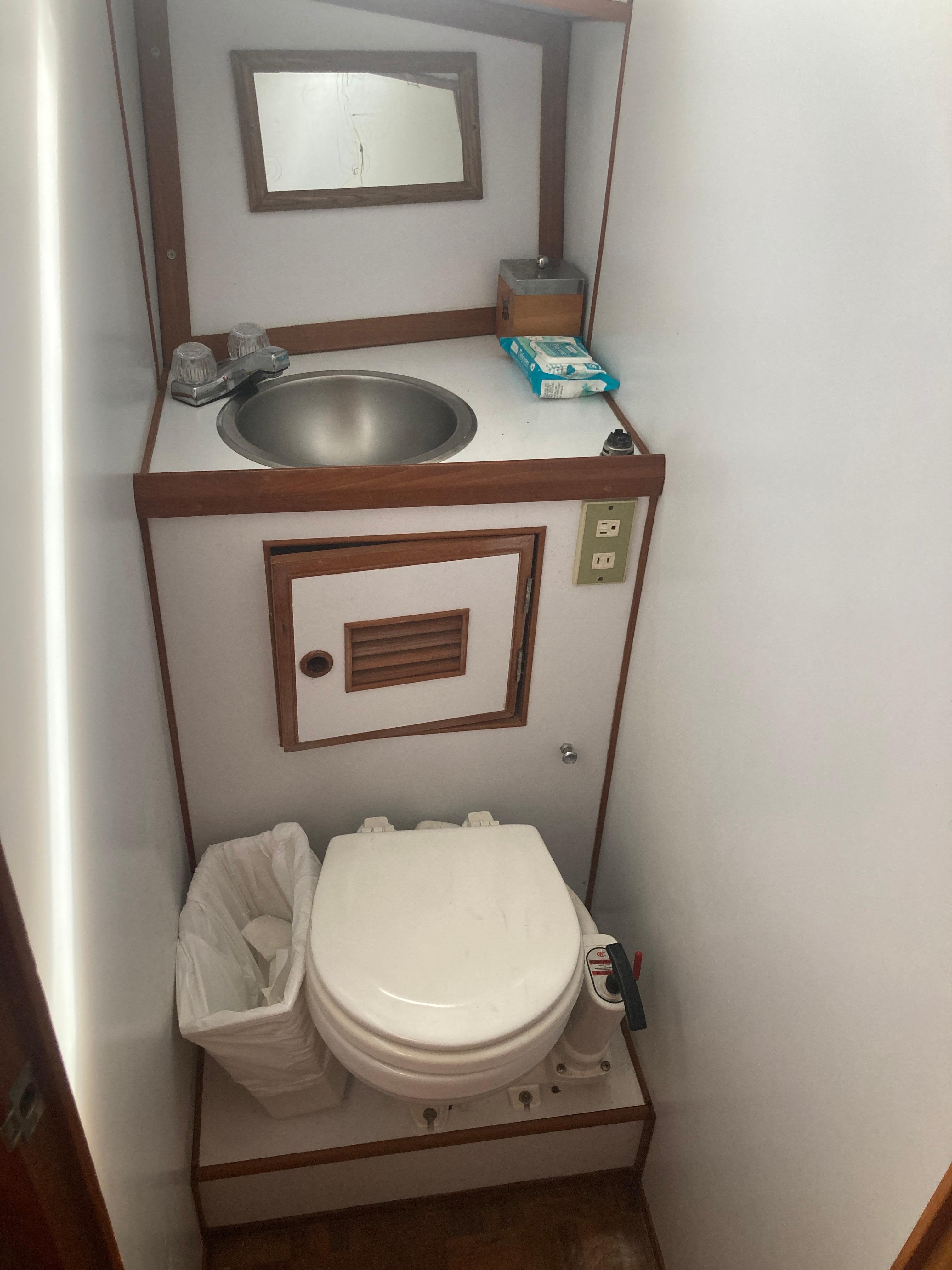 Slide: The Image of Compact bathroom in 1981 Monk Comfort Monk Motorsailer 38 with sink, mirror, and toilet. - 19