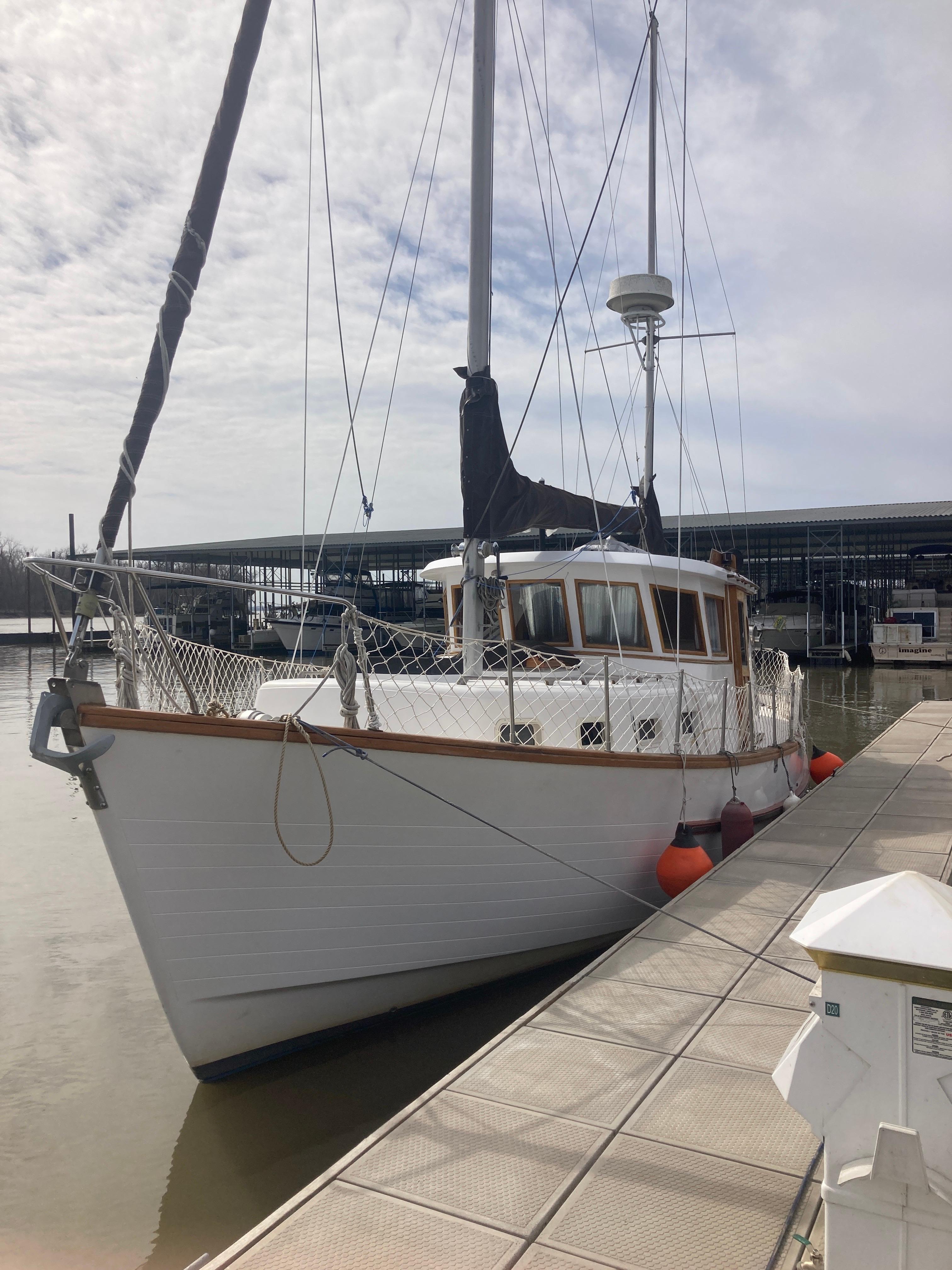 Slide: The Image of 1981 Monk Comfort Monk Motorsailer 38 docked at marina. - 2