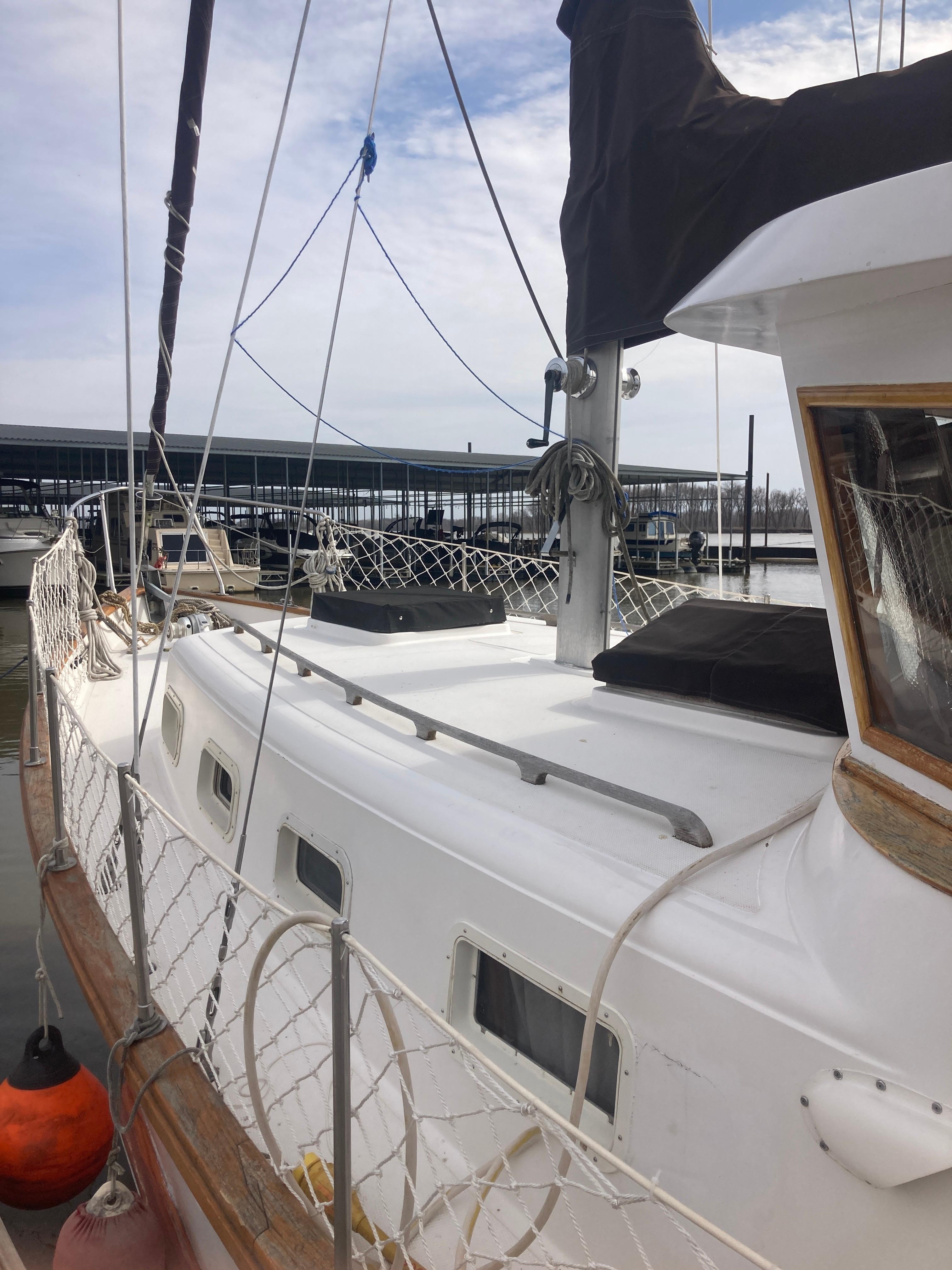 Slide: The Image of 1981 Monk Comfort Monk Motorsailer 38 docked at marina, side view. - 3