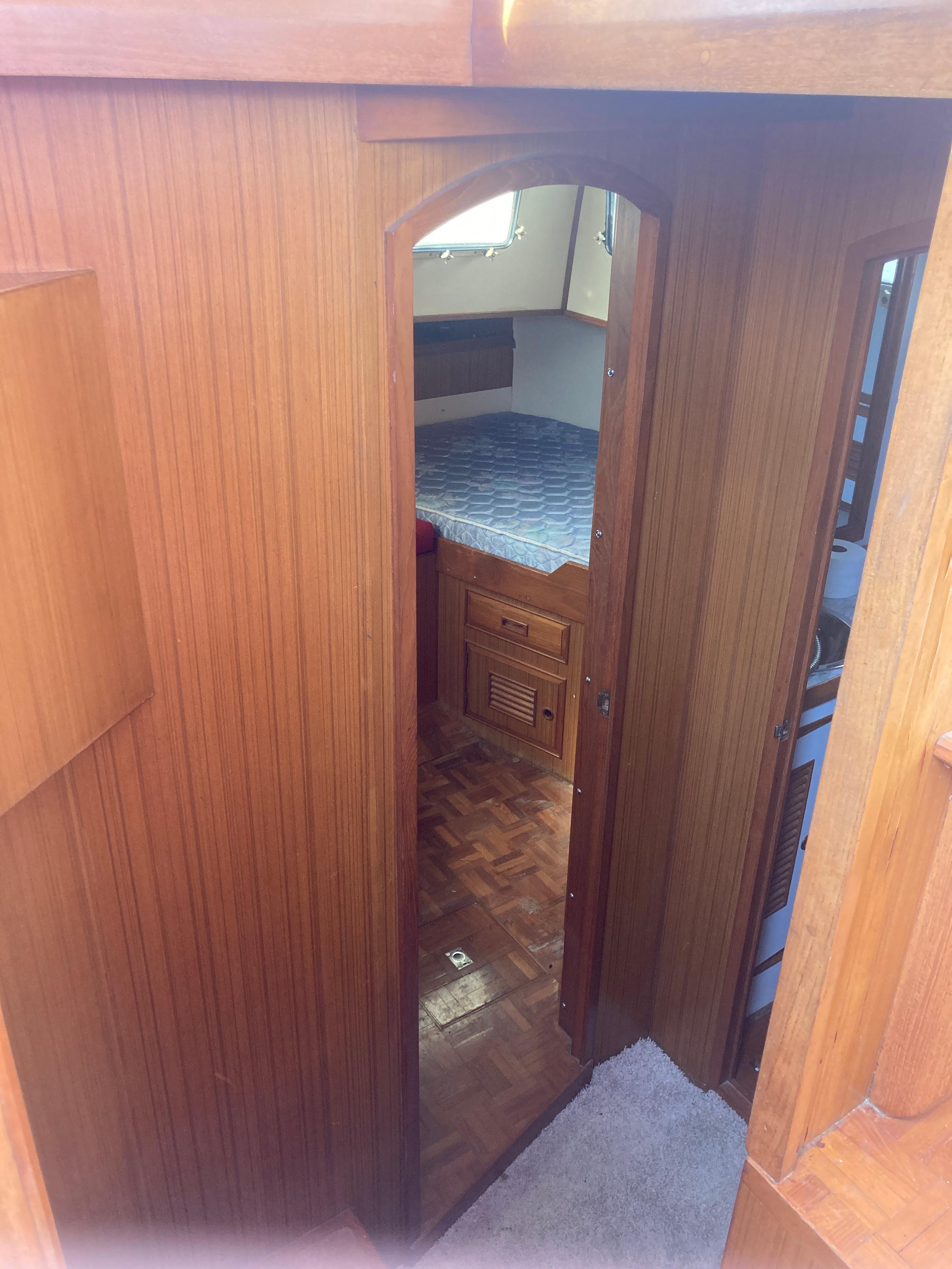 Slide: The Image of Interior of 1981 Monk Comfort Monk Motorsailer 38, featuring wooden paneling and cozy cabin. - 5