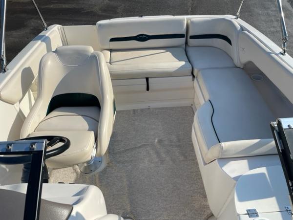 Slide: The Image of 2001 Monterey Explorer 220 Sport boat interior with white seating and steering wheel. - 1