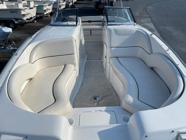 Slide: The Image of 2001 Monterey Explorer 220 Sport boat interior with white seating and open deck. - 10