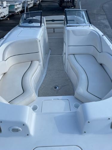 Slide: The Image of 2001 Monterey Explorer 220 Sport boat interior with white seating and open deck. - 11