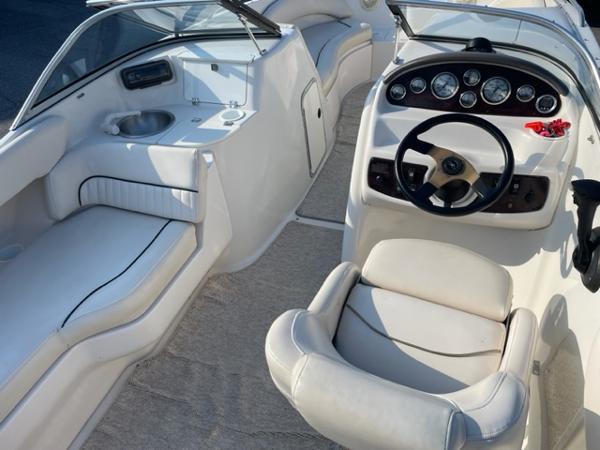 Slide: The Image of Interior of a 2001 Monterey Explorer 220 Sport boat with steering wheel and seating. - 12