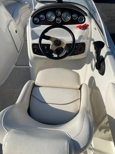 Slide: The Image of 2001 Monterey Explorer 220 Sport boat cockpit with steering wheel and gauges. - 13