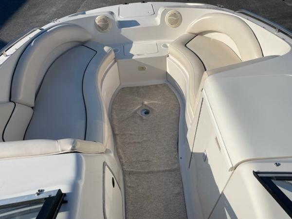 Slide: The Image of 2001 Monterey Explorer 220 Sport boat interior with white seating and carpeted floor. - 14