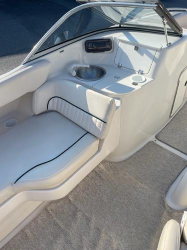 Slide: The Image of 2001 Monterey Explorer 220 Sport boat interior with white seating and sink. - 2
