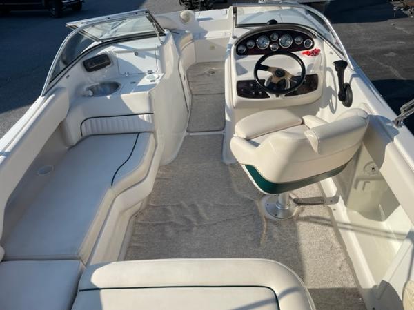 Slide: The Image of 2001 Monterey Explorer 220 Sport boat interior with white seating and steering console. - 3