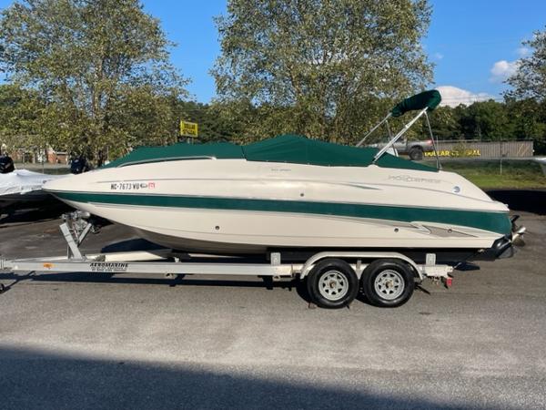Slide: The Image of 2001 Monterey Explorer 220 Sport boat on a trailer with green cover. - 7