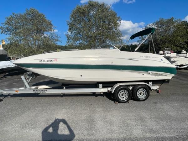 Slide: The Image of 2001 Monterey Explorer 220 Sport boat on a trailer in a parking lot. - 8
