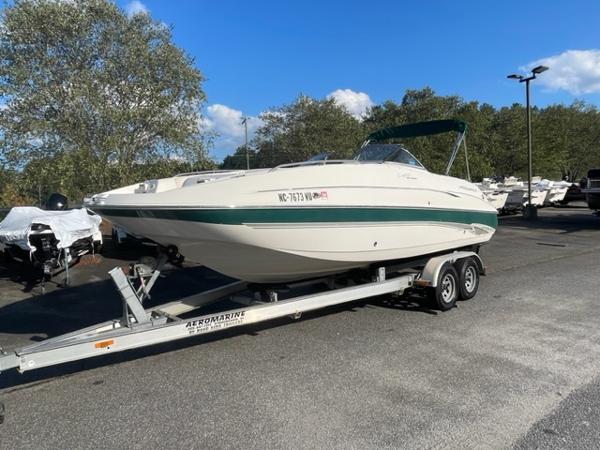 Slide: The Image of 2001 Monterey Explorer 220 Sport boat on a trailer in a parking lot. - 9