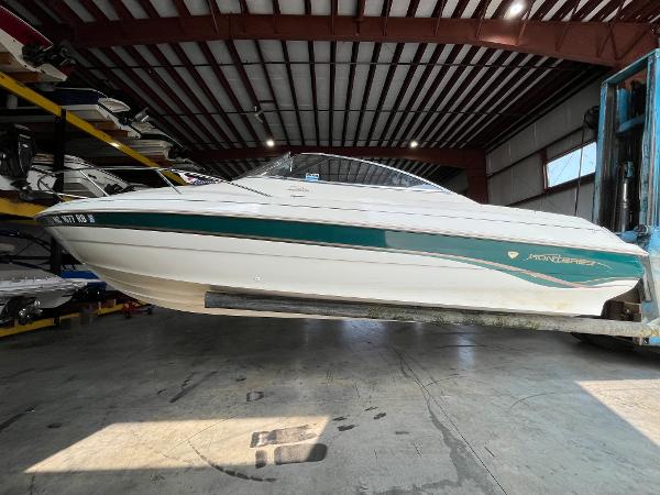 Slide: The Image of 1997 Monterey 236 Montura boat in a storage facility. - 1