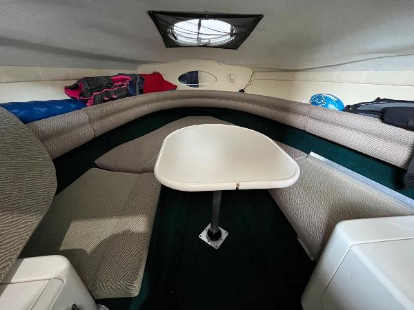 Slide: The Image of Interior cabin of a 1997 Monterey 236 Montura boat with seating and table. - 19