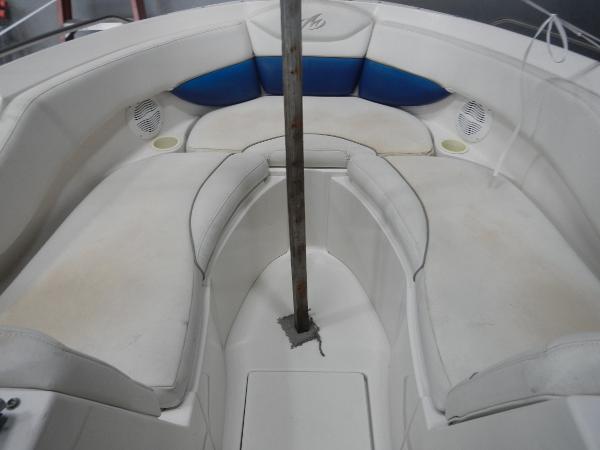 Slide: The Image of 2005 Monterey 248 LS boat interior with white and blue seating. - 10