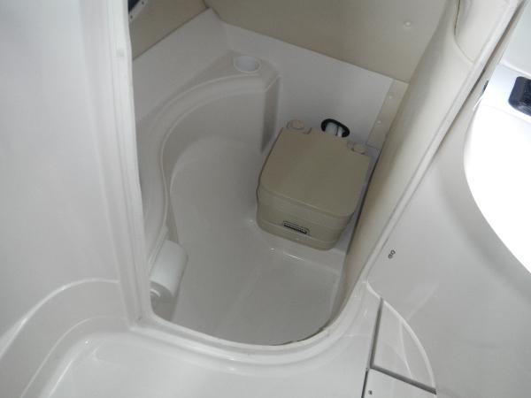 Slide: The Image of 2005 Monterey 248 LS boat interior bathroom with portable toilet. - 11