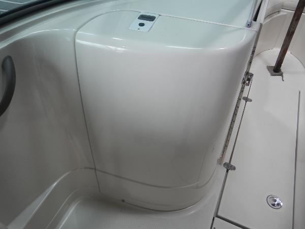 Slide: The Image of Interior of 2005 Monterey 248 LS boat, showing storage compartment and seating area. - 12