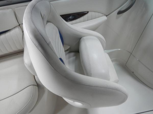 Slide: The Image of 2005 Monterey 248 LS boat interior with white leather seats. - 13