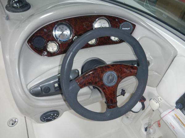 Slide: The Image of 2005 Monterey 248 LS boat dashboard with steering wheel and instrument panel. - 14